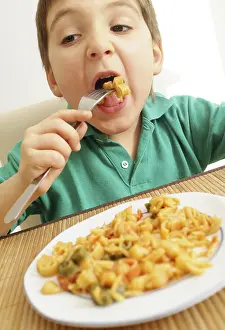 Balanced Diet For Children Drucke: Boy eats pasta dish