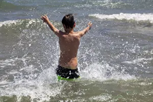 Joyful Childhood Moments Drucke: Boy has fun in the sea