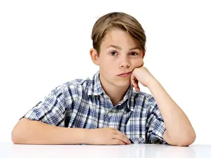 Caucasian Child Portrait Drucke: Boy, looking serious, with his hand supporting his head