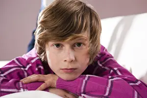 One Person Studio Photo Drucke: Boy lying on a couch with a contemplative expression