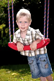 Caucasian Child Looking At Camera Drucke: Boy playing on the playground