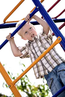Caucasian Child Playing Drucke: Boy playing on the playground