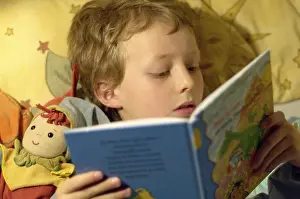 Childhood Leisure Activities Drucke: Boy reading in bed