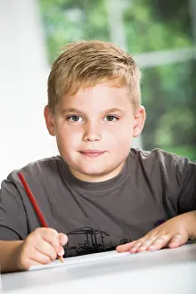 Educational Institution Photos Drucke: Boy with a sketch-pad at a table
