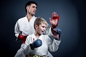 Martial Art Practice Drucke: Boy with his trainer in a karate pose