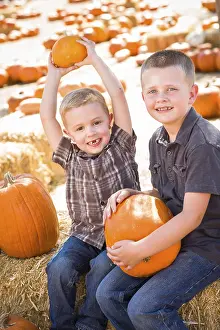 Pumpkin Patch Kids Drucke: Two boys at the pumpkin patch talking about their pumpkins and having fun on a fall day