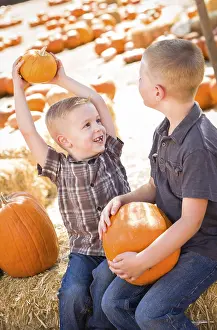 Pumpkin Patch Kids Drucke: Two boys at the pumpkin patch talking about their pumpkins and having fun on a fall day