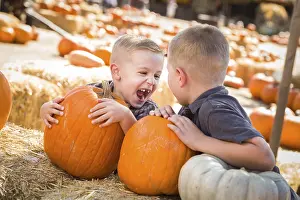 Pumpkin Patch Kids Drucke: Two boys at the pumpkin patch talking about their pumpkins and having fun on a fall day