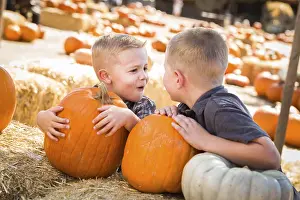 Pumpkin Patch Kids Drucke: Two boys at the pumpkin patch talking about their pumpkins and having fun on a fall day