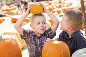 Pumpkin Patch Kids Drucke: Two boys at the pumpkin patch talking about their pumpkins and having fun on a fall day