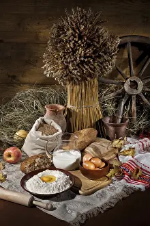 Wholemeal Bread Drucke: Bread, flowers, ild tableware on a canvas studio background