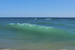 Southern Europe Coast Drucke: Breaking waves on a beach, sunny