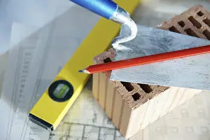 Construction Plan Drucke: Brick trowl and brick on a construction plan