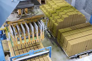 Factory Plant Equipment Drucke: Brickyard. Top view of machine and stacked bricks in workshop
