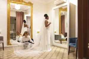 White Wedding Attire Drucke: Bride stands elegantly in a fitting room