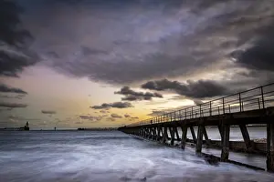 Overcast Sky In Europe Drucke: Bridge in the sea with dramatic clouds at sunset