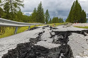 Deserted Mountain Roads Drucke: Broken road with cracks in the road surface