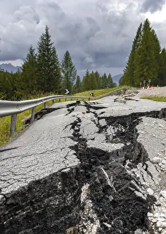 Deserted Roadside Scene Drucke: Broken road with cracks in the road surface