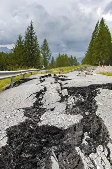 Deserted Mountain Roads Drucke: Broken road with cracks in the road surface