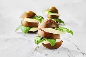 Healthy Lunch Meal Ideas Drucke: Brown chocolate tomato, mozzarella and basil cutted on slices and stacked on marble background (selective focus photo)