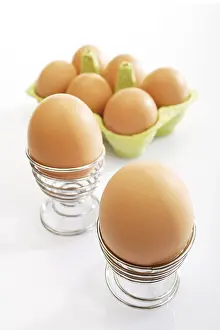 Studio Shot Of Brown Eggs Drucke: Brown eggs in spiral eggcups