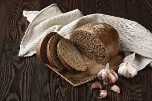 Garlic Nutrition Drucke: Brown garlic bread on cutting board on the table