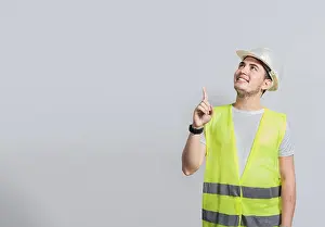 Adult Male Construction Worker Drucke: Builder engineer pointing finger to the right isolated