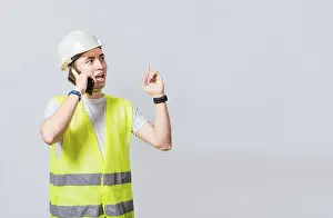 Civil Engineer Drucke: Builder engineer in vest talking on cell phone isolated