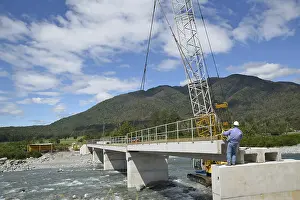Concrete Bridge Construction Drucke: Builders construct a concrete bridge over a small river in Westland