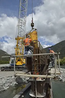 Concrete Bridge Construction Drucke: Builders construct a concrete bridge over a small river in Westland