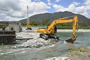Concrete Bridge Construction Drucke: Builders create a new channel to control the river while they construct a concrete bridge over a small river
