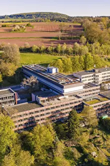 Southern Germany Administrative Building Drucke: Building complex with solar panels surrounded by fields
