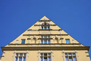 Clear Sky Photography Drucke: Building with striking triangular gable and windows against a clear sky