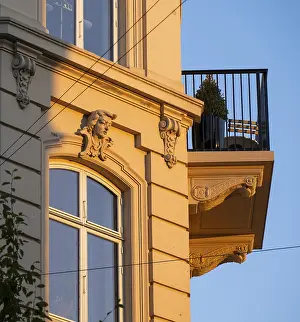 Scandinavian Building Design Drucke: A building in warm evening light with decorative facade elements and balcony