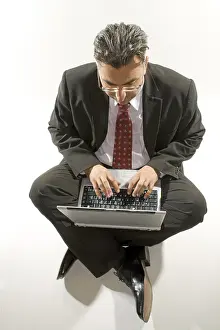 Man Working On Computer Drucke: Businessman with a notebook on his lap