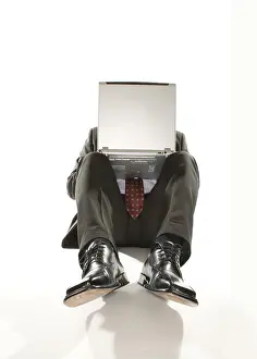 Man Working On Computer Drucke: Businessman with a notebook on his lap