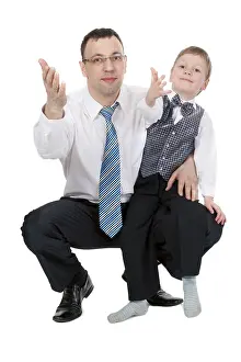 Young Entrepreneur Drucke: Businessman and his son pulled his hands in the studio