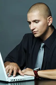 Business Attire Man Drucke: A businessman using laptop computer