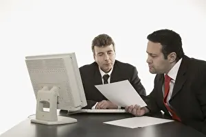 Business Professionals Meeting Drucke: Two businessmen going over documents