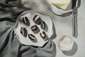 Rustic Ceramic Plate Drucke: Butter stuffed dates are elegantly presented on a rustic ceramic plate