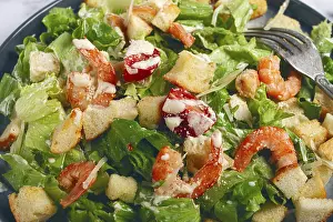 Healthy Seafood Meal Ideas Drucke: Caesar salad, with shrimp, on a marble background