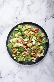 High Angle View Of A Dish Drucke: Caesar salad, with shrimp, on a marble background