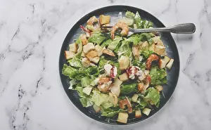 Healthy Seafood Meal Ideas Drucke: Caesar salad, with shrimp, on a marble background