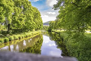Blue Summer Sky Drucke: A calm river, surrounded by green trees