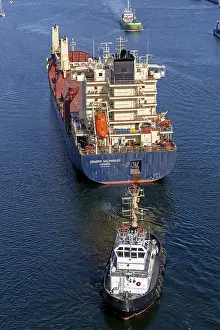 Transporting Goods By Sea Drucke: Cargo ship waiting in front of the lock