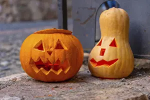Halloween Pumpkins Drucke: Two carved pumpkins with faces on them sit on a stone surface