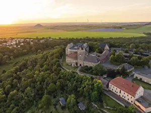 Deserted Castle Evening Drucke: A castle surrounded by forests and fields at sunset