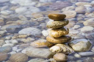 Rocky Coastline Photo Drucke: Stack of pebbles on the beach