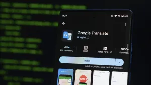 Digital Communication Tools Drucke: Google Translate app displayed on a smartphone with a coding interface background