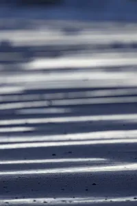 Dutch Coastline Photography Drucke: Line patterns of light and shadow on the sand surface on the beach form a graphic pattern